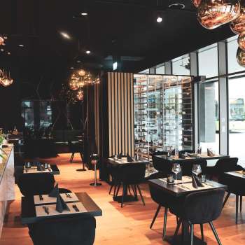Interno di un ristorante moderno con eleganti tavoli e sedie nere