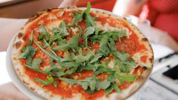 Insalata caprese con pomodori, mozzarella, basilico e condimento balsamico, accompagnata da pane fresco