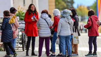 Visita guidata City-ClassicTour nella città di Vaduz Gruppo di turisti con guida della città in cappotto rosso durante una visita guidata nel centro di Vaduz, in Liechtenstein