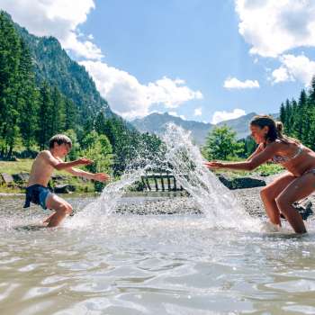I bambini sguazzano nel Lago Gänglesee a Steg