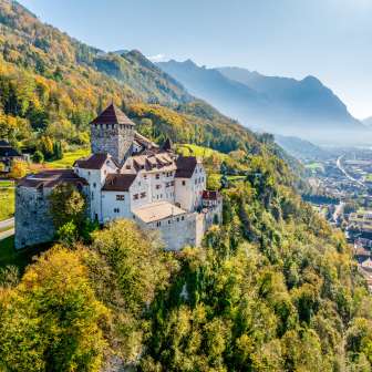 Il castello di Vaduz in Liechtenstein nell'autunno dorato, con vista sulla valle alpina del Reno e sulla città di Vaduz
